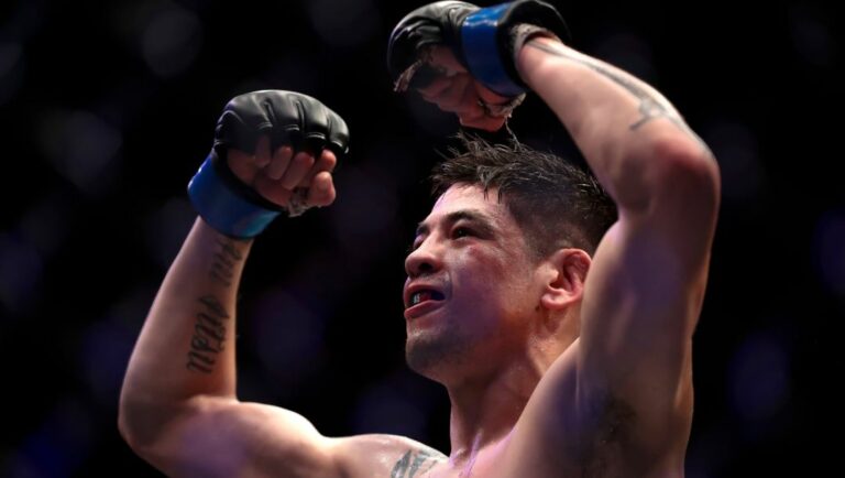 Mexico's Brandon Moreno, celebrates victory over Brazil's Gilbert Durinho in their flyweight title bout at the UFC 283.