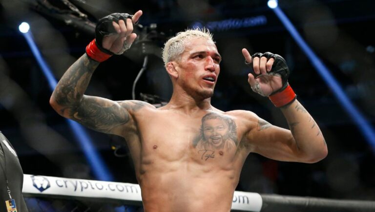 Charles Oliveira reacts after defeating Dustin Poirier by submission in a lightweight mixed martial arts title bout at UFC 269.