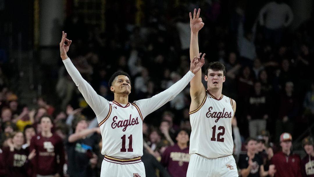 Boston College guard Makai Ashton-Langford (11) and forward Quinten Post (12) celebrateduring an NCAA college basketball game, Wednesday, Feb. 22, 2023, in Boston.