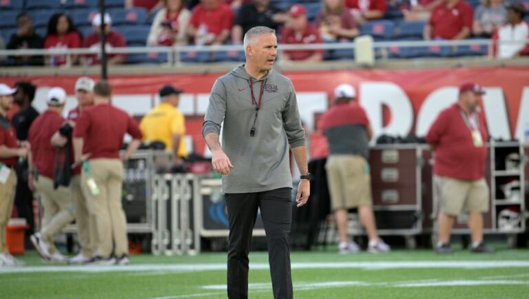 Florida State head coach Mike Norvell watches players warm up before the Cheez-It Bowl NCAA college football game against Oklahoma, Thursday, Dec. 29, 2022, in Orlando, Fla.