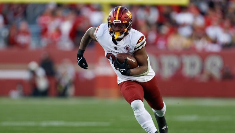 Washington Commanders running back Antonio Gibson rushes the ball in the second half of an NFL football game against the San Francisco 49ers, Saturday, Dec. 24, 2022, in Santa Clara, Calif.