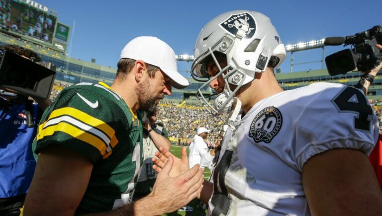 Green Bay Packers' Aaron Rodgers talks to Oakland Raiders' Derek Carr after an NFL football game Sunday, Oct. 20, 2019, in Green Bay, Wis. The Packers won 42-24. (AP Photo/Jeffrey Phelps)