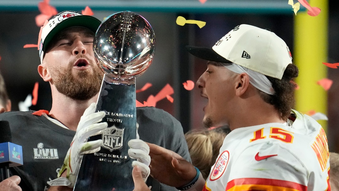Kansas City Chiefs tight end Travis Kelce, left, and quarterback Patrick Mahomes (15) holds the Vince Lombardi Trophy after the NFL Super Bowl 57 football game against the Philadelphia Eagles, Sunday, Feb. 12, 2023, in Glendale, Ariz. The Kansas City Chiefs defeated the Philadelphia Eagles 38-35. (AP Photo/Marcio J. Sanchez)