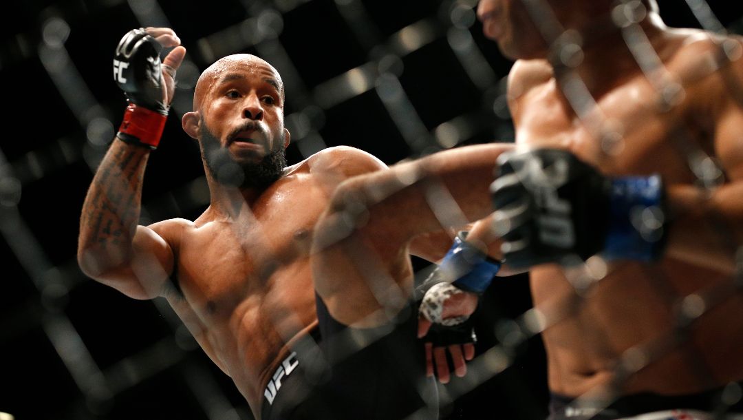 Demetrious Johnson kicks John Dodson during their flyweight title mixed martial arts bout at UFC 191, Saturday, Sept. 5, 2015.