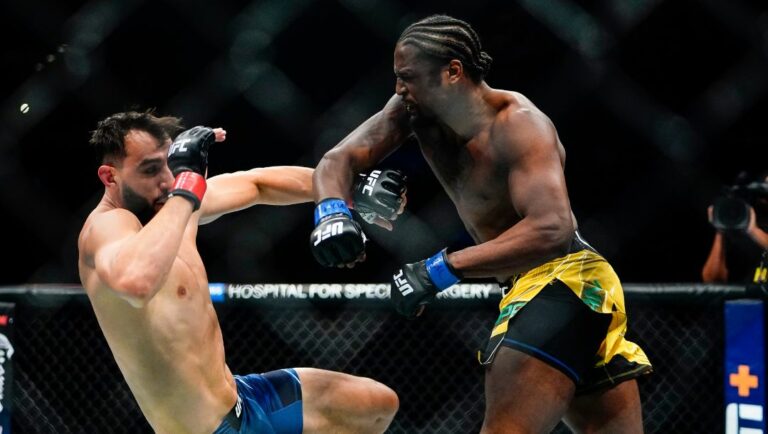 Ryan Spann, right, punches Dominick Reyes during the first round of a light heavyweight bout at the UFC 281 mixed martial arts.