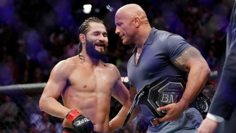 Jorge Masvidal, left, talks to Dwayne "The Rock" Johnson after a welterweight mixed martial arts bout against Nate Diaz at UFC 244.