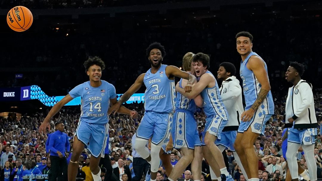North Carolina players celebrate their victory against Duke after a college basketball game in the semifinal round of the Men's Final Four NCAA tournament, Saturday, April 2, 2022, in New Orleans. North Carolina won 81-77. With four starters back from the team that blew a 15-point halftime lead to Kansas at the Superdome in New Orleans, the Tar Heels were the runaway pick as the preseason No. 1 in the AP Top 25 on Monday, Oct. 17, 2022.