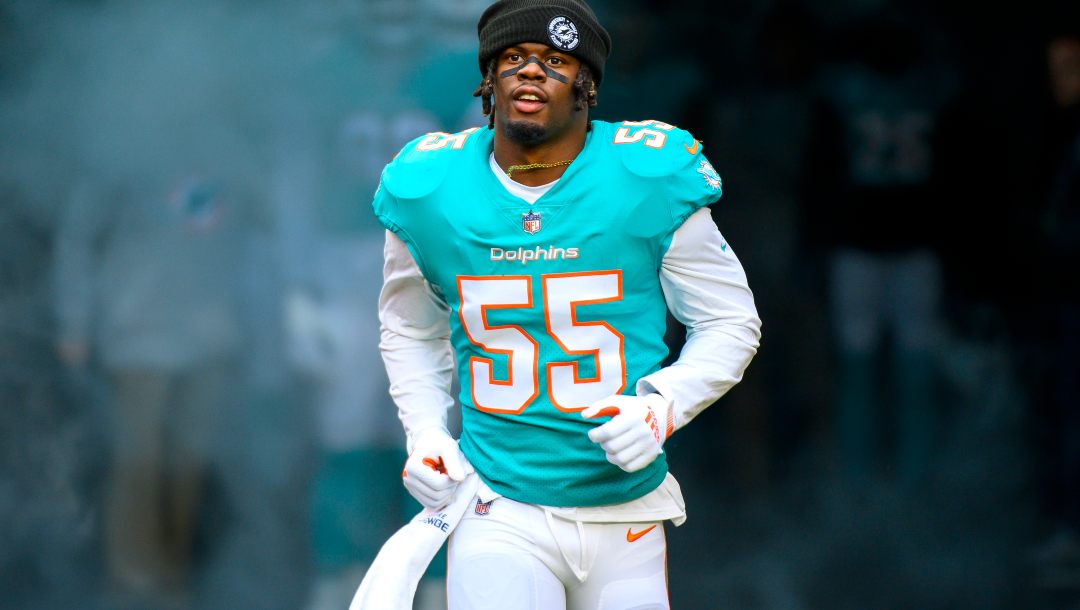 Miami Dolphins linebacker Jerome Baker (55) is introduced to the fans and runs onto the field before an NFL football game against the Green Bay Packers, Sunday, Dec. 25, 2022, in Miami Gardens, Fla.
