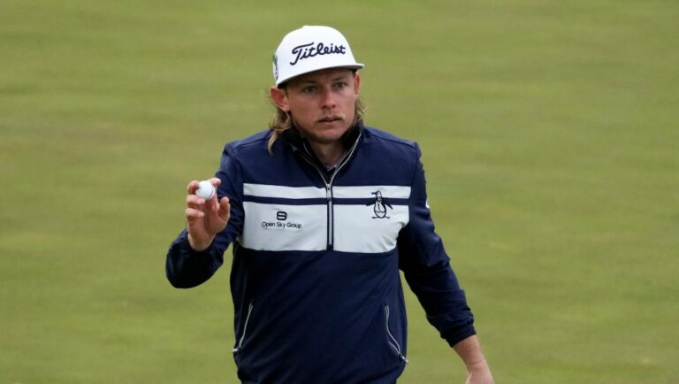 Cameron Smith, of Australia, holds up his ball after a birdie on the 15th hole during the third round at the Masters golf tournament on Saturday, April 9, 2022, in Augusta, Ga.