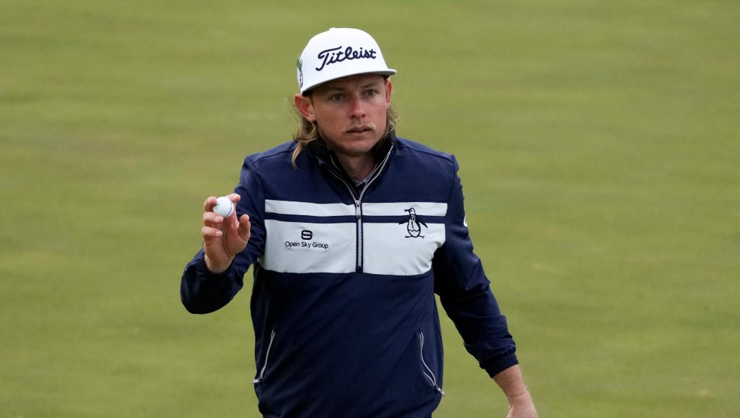 Cameron Smith, of Australia, holds up his ball after a birdie on the 15th hole during the third round at the Masters golf tournament on Saturday, April 9, 2022, in Augusta, Ga.