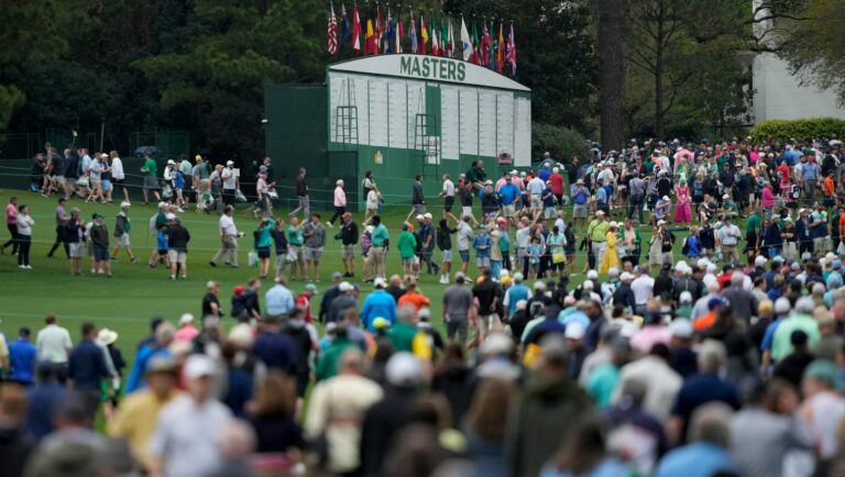 Spectators leave Augusta National Golf Course after a weather warning was issued during a practice round at the Masters golf tournament on Wednesday, April 6, 2022, in Augusta, Ga.