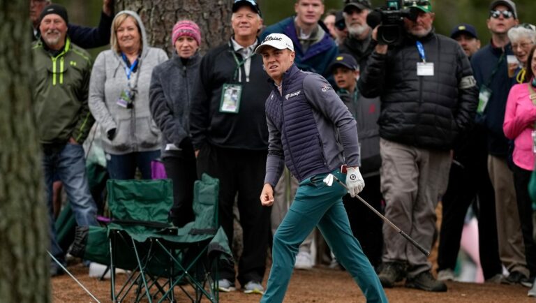 Justin Thomas watches his shot from the pine straw on the first fairway during the third round at the Masters golf tournament on Saturday, April 9, 2022, in Augusta, Ga.