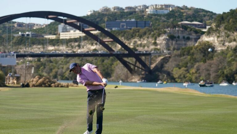 Scottie Scheffler hits his approach on the 14th hole in the final round of the Dell Technologies Match Play Championship golf tournament, Sunday, March 27, 2022, in Austin, Texas.