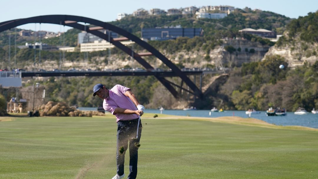 Scottie Scheffler hits his approach on the 14th hole in the final round of the Dell Technologies Match Play Championship golf tournament, Sunday, March 27, 2022, in Austin, Texas.