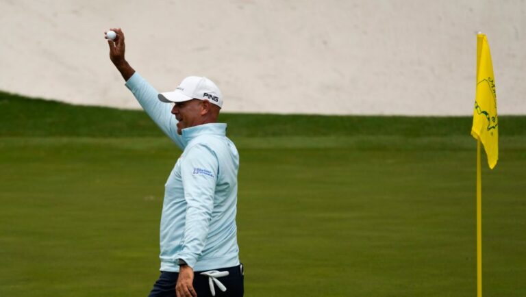 Stewart Cink holds up his ball after a hole-in-one on the 16th hole during the second round at the Masters golf tournament on Friday, April 8, 2022, in Augusta, Ga.