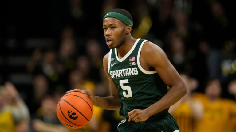 Michigan State guard Tre Holloman drives up court during an NCAA college basketball game against Iowa, Saturday, Feb. 25, 2023, in Iowa City, Iowa. (AP Photo/Charlie Neibergall)