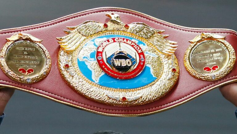Filipino boxer Manny Pacquiao raises his WBO welterweight championship belt during a news conference upon arrival from Los Angeles.