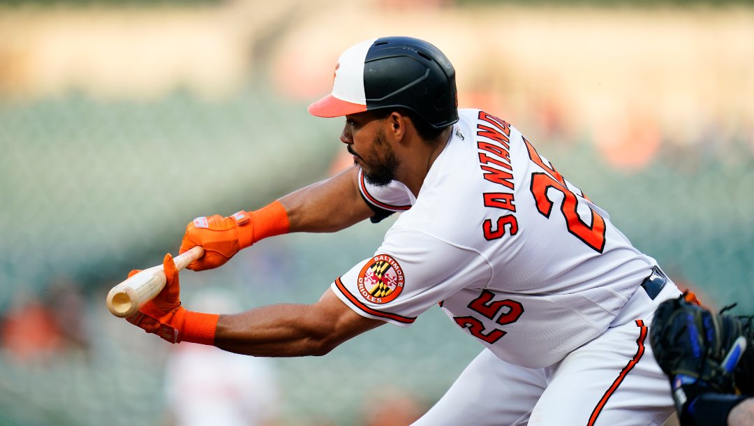 Baltimore Orioles' Anthony Santander bunts for a single against the Texas Rangers during the first inning of a baseball game, Tuesday, July 5, 2022, in Baltimore.