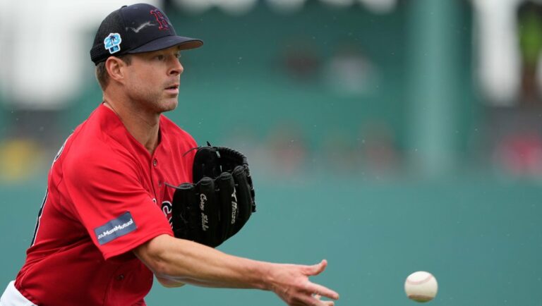 Boston Red Sox starting pitcher Corey Kluber tosses to first on an infield groundout by Tampa Bay Rays Ben Gamel in the fourth inning of a spring training baseball game in Fort Myers, Fla., Wednesday, March 15, 2023.