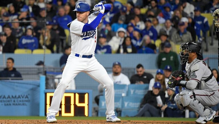 Los Angeles Dodgers' Freddie Freeman, left, stands at bat as Arizona Diamondbacks catcher Gabriel Moreno kneels behind the plate as the pitch clock runs down during the third inning of an opening day baseball game Thursday, March 30, 2023, in Los Angeles.