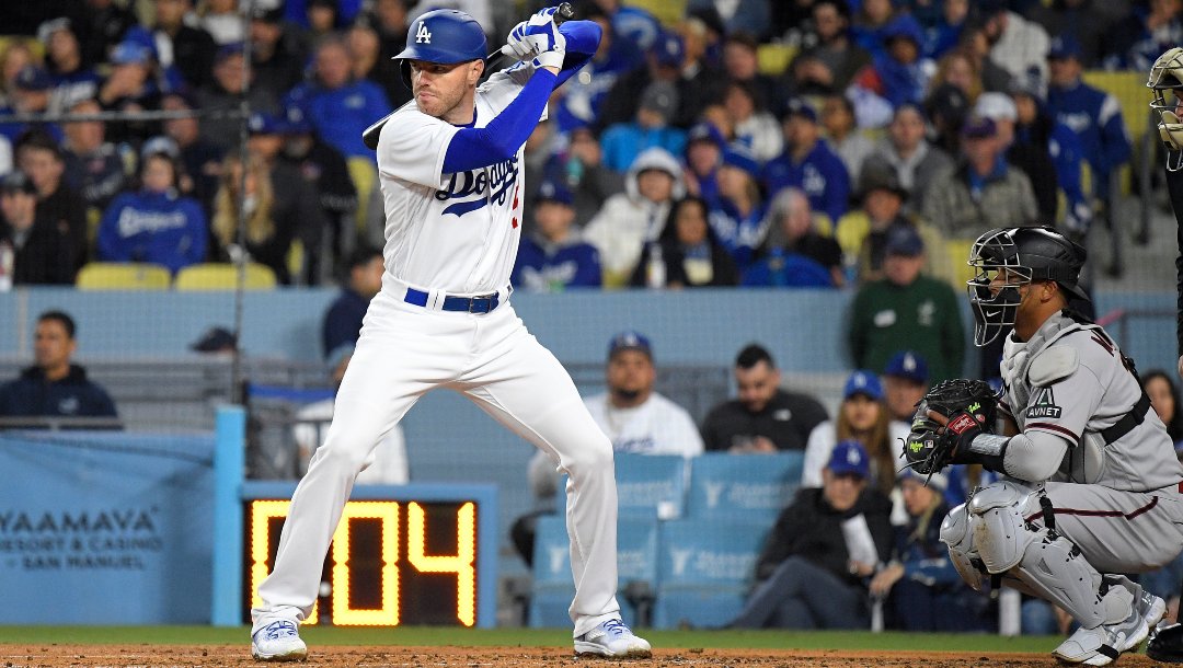Los Angeles Dodgers' Freddie Freeman, left, stands at bat as Arizona Diamondbacks catcher Gabriel Moreno kneels behind the plate as the pitch clock runs down during the third inning of an opening day baseball game Thursday, March 30, 2023, in Los Angeles.