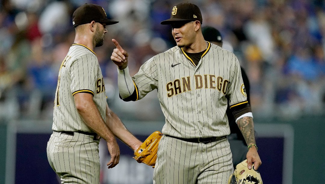 San Diego Padres' Manny Machado, right, and relief pitcher Nick Martinez celebrate after their baseball game against the Kansas City Royals Saturday, Aug. 27, 2022, in Kansas City, Mo.