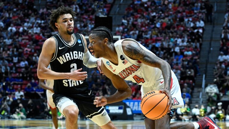 Arizona guard Dalen Terry (4) drives around Wright State guard Tanner Holden (2) during the second half of a first-round NCAA college basketball tournament game, Friday, March 18, 2022, in San Diego. Arizona won 87-70. (AP Photo/Denis Poroy)