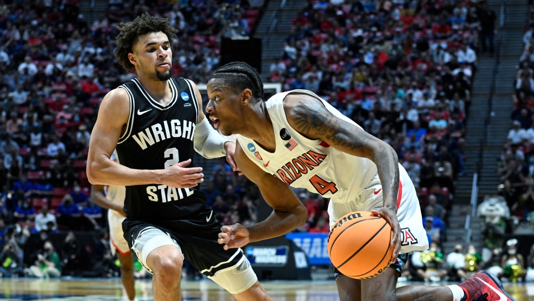 Arizona guard Dalen Terry (4) drives around Wright State guard Tanner Holden (2) during the second half of a first-round NCAA college basketball tournament game, Friday, March 18, 2022, in San Diego. Arizona won 87-70. (AP Photo/Denis Poroy)