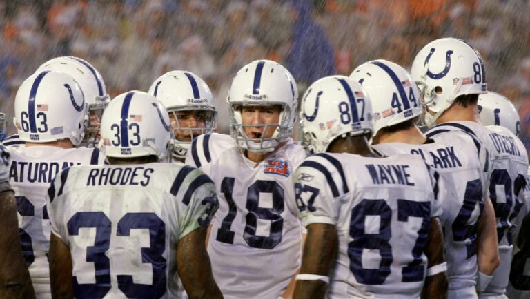 FILE - In this Feb. 4, 2007, file photo, Indianapolis Colts quarterback Peyton Manning (18) talks to teammates in a huddle in the rain during the third quarter against the Chicago Bears in NFL football's Super Bowl XLI in Miami. The Colts won 29-17. (AP Photo/Alex Brandon, file)