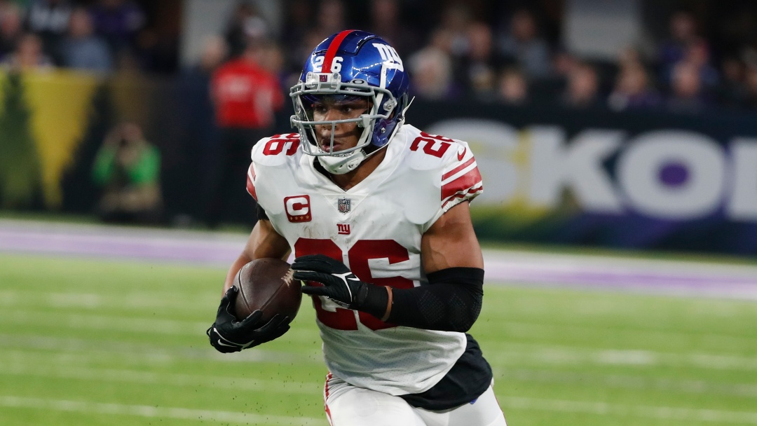 New York Giants' Saquon Barkley runs during the first half of an NFL wild card football game against the Minnesota Vikings Sunday, Jan. 15, 2023, in Minneapolis. (AP Photo/Bruce Kluckhohn)