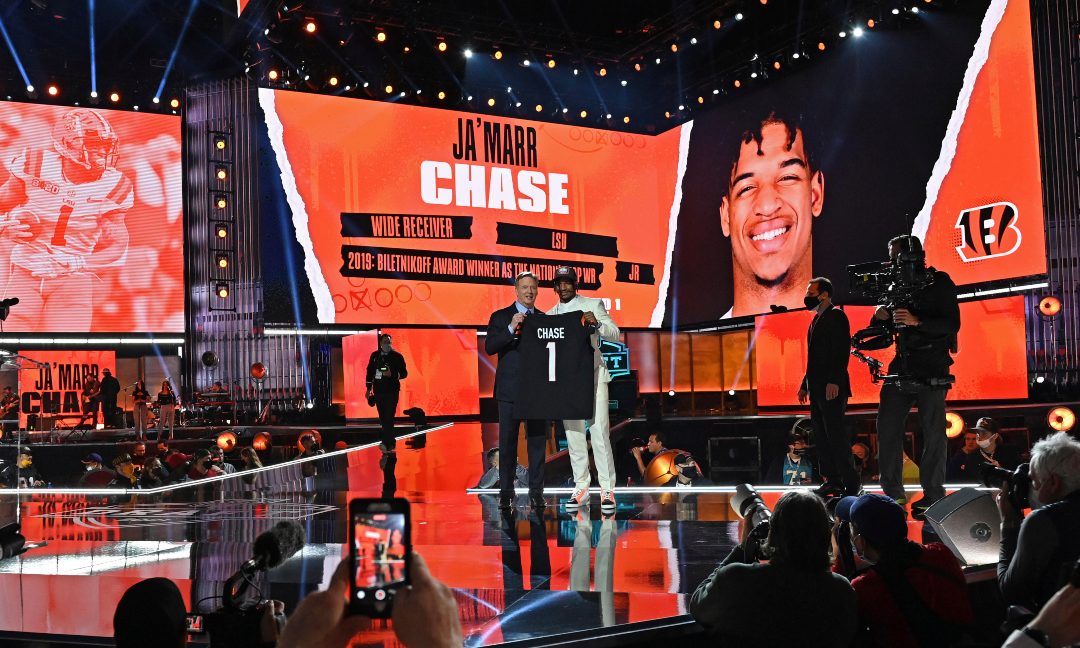LSU wide receiver Ja'Marr Chase, right, holds a team jersey with NFL Commissioner Roger Goodell after the Cincinnati Bengals selected Wilson with the fifth pick in the first round of the NFL football draft Thursday April 29, 2021, in Cleveland.
