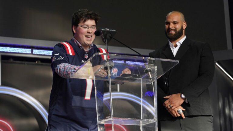 Ben Lepper of Make-A-Wish, left and Lawrence Guy announce the New England Patriots 50th pick during the 2022 NFL Draft on Friday, April 29, 2022, in Las Vegas.