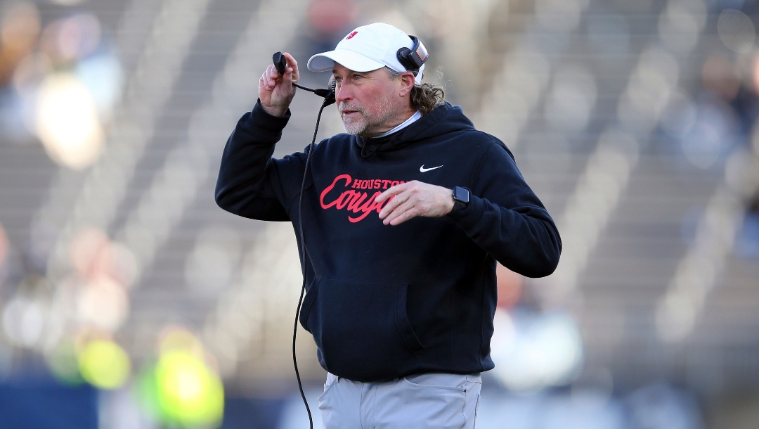 Houston head coach Dana Holgorsen walks onto the field during the first half of an NCAA football game against Connecticut, Saturday, Nov. 27, 2021, in East Hartford, Conn. (AP Photo/Stew Milne)