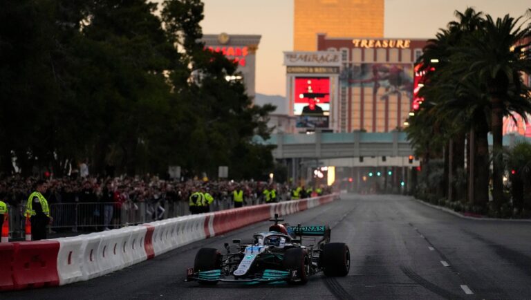 George Russell drives during a demonstration along the Las Vegas Strip at a launch party for the Formula One Las Vegas Grand Prix, Saturday, Nov. 5, 2022, in Las Vegas. (AP Photo/John Locher)