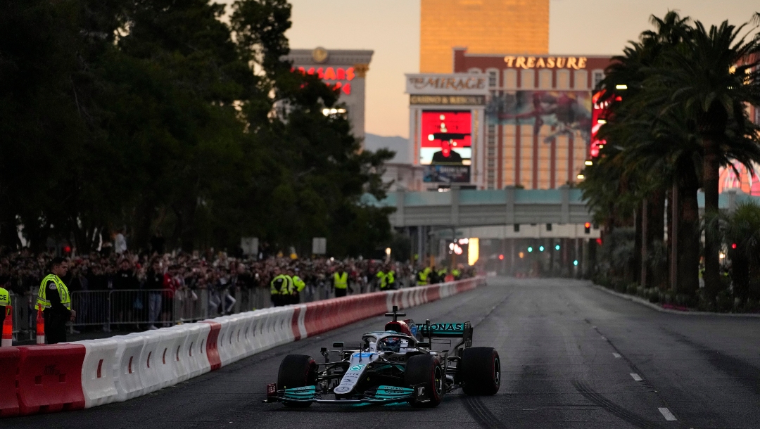 George Russell drives during a demonstration along the Las Vegas Strip at a launch party for the Formula One Las Vegas Grand Prix, Saturday, Nov. 5, 2022, in Las Vegas. (AP Photo/John Locher)