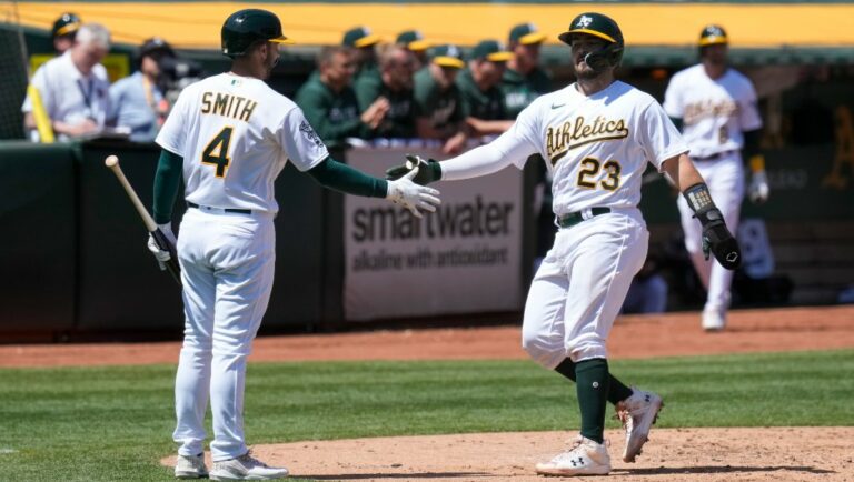 Oakland Athletics' Shea Langeliers, right, celebrates with Kevin Smith after scoring against the Chicago Cubs on Carlos Pérez's double during the fourth inning of a baseball game in Oakland, Calif., Wednesday, April 19, 2023.