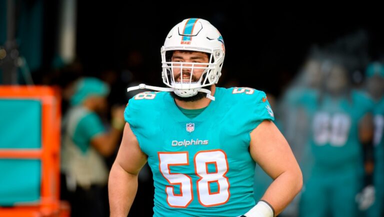 Miami Dolphins offensive lineman Connor Williams (58) runs onto the field as he is introduced to the fans before an NFL football game against the New York Jets, Sunday, Jan. 8, 2023, in Miami Gardens, Fla. (AP Photo/Doug Murray)