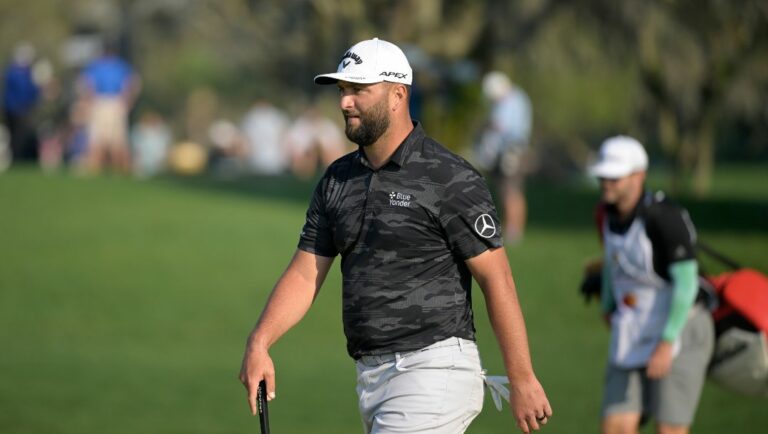 Jon Rahm, left, of Spain, walks onto the 13th green during the second round of the Arnold Palmer Invitational golf tournament, Friday, March 3, 2023, in Orlando, Fla.