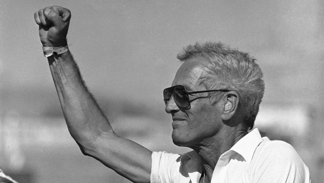 Paul Newman gestures to driver Danny Sullivan as the Newman-Budweiser racing team wins the Coors Can-Am portion of the Caesars Palace Grand Prix in Las Vegas Sunday, Sept. 26, 1982. It is the second straight year that Sullivan has won the race. (AP Photo)