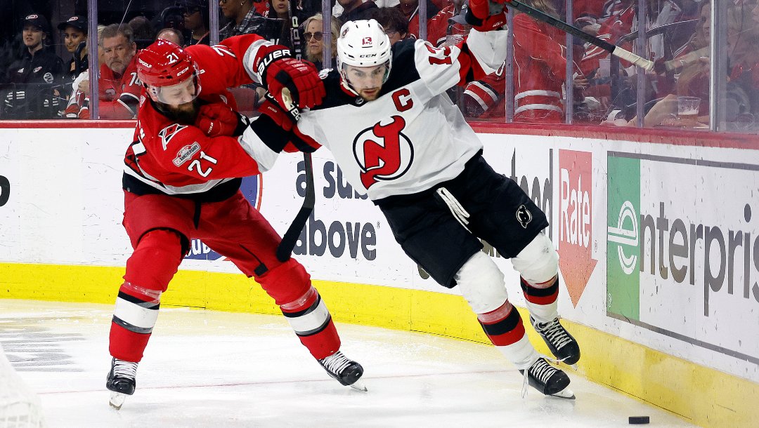 New Jersey Devils' Nico Hischier (13) works agains Carolina Hurricanes' Derek Stepan (21) during the third period of Game 5 of an NHL hockey Stanley Cup second-round playoff series in Raleigh, N.C., Thursday, May 11, 2023.