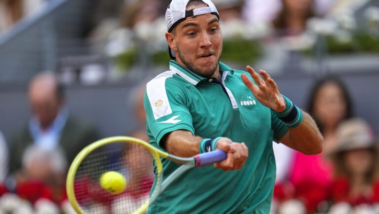 Jan-Lennard Struff, of Germany, returns the ball against Carlos Alcaraz, of Spain, during their men's singles final match at the Madrid Open tennis tournament in Madrid, Spain, Sunday, May 7, 2023.