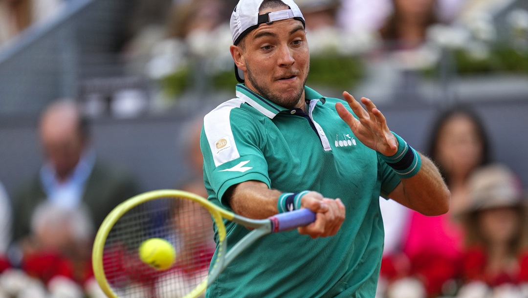 Jan-Lennard Struff, of Germany, returns the ball against Carlos Alcaraz, of Spain, during their men's singles final match at the Madrid Open tennis tournament in Madrid, Spain, Sunday, May 7, 2023.