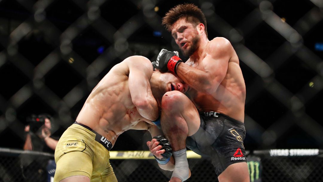 Henry Cejudo, right, kicks Marlon Moraes during their bantamweight title mixed martial arts bout at UFC 238.
