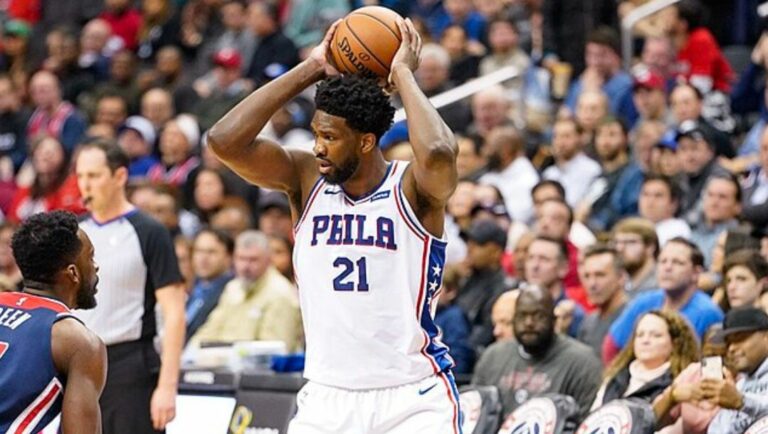 Joel Embiid of the Philadelphia 76ers looks to attack the basket against his defender against the Wizards in 2019.