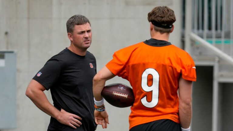 Cincinnati Bengals quarterback Joe Burrow (9) speaks with head coach Zac Taylor during practice at the team's NFL football training facility, Tuesday, June 13, 2023, in Cincinnati.