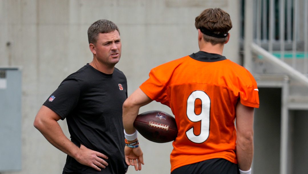 Cincinnati Bengals quarterback Joe Burrow (9) speaks with head coach Zac Taylor during practice at the team's NFL football training facility, Tuesday, June 13, 2023, in Cincinnati.