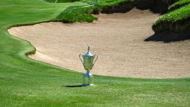 The championship trophy is displayed next to a bunker at the 18th hole during the First Look for the 123rd U.S. Open Championship at Los Angeles Country Club, Monday, Sept. 26, 2022, in Los Angeles. The final three holes are par 4s that average 518 yards. The U.S. Open starts Thursday, June 15, 2023.
