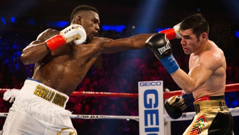 Carlos Adames, left, of the Dominican Republic, throws a left at Alejandro Barrera, of Mexico, in their welterweight boxing match.