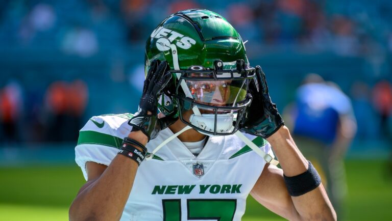 New York Jets wide receiver Garrett Wilson (17) puts on his helmet before an NFL football game against the Miami Dolphins, Sunday, Jan. 8, 2023, in Miami Gardens, Fla. (AP Photo/Doug Murray)