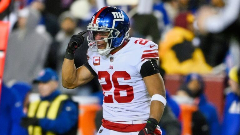 New York Giants running back Saquon Barkley (26) gestures during the first half of an NFL football game against the Washington Commanders, Sunday, Dec. 18, 2022, in Landover, Md.